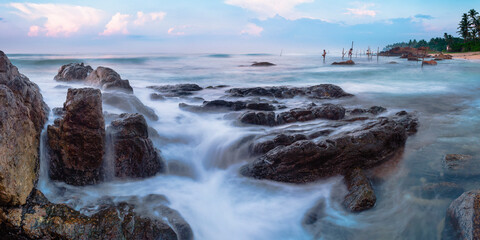 Fototapeta premium Stilt fishermen at Midigama Beach at sunrise, near Weligama, South Coast, Sri Lanka, Asia