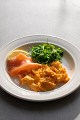 Scrambled eggs, smoked salmon and pea shoots salad