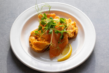 Scrambled eggs, smoked salmon and pea shoots salad