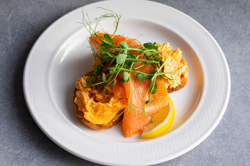 Scrambled eggs, smoked salmon and pea shoots salad
