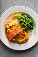 Scrambled eggs, smoked salmon and pea shoots salad