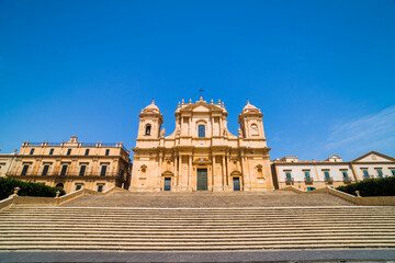Fototapeta premium Noto, St Nicholas Cathedral (Cattedrale di Noto, Duomo) at the top on an enormous set of Baroque steps, Piazza Municipio, Noto, South East Sicily, Italy, Europe