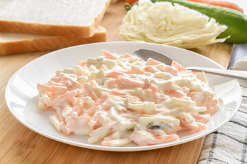 Creamy coleslaw salad on a white plate. 