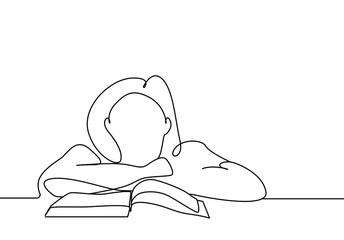 girl with her head on the table in front of the book thinks