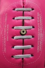 Close up of a pink Australian rules football