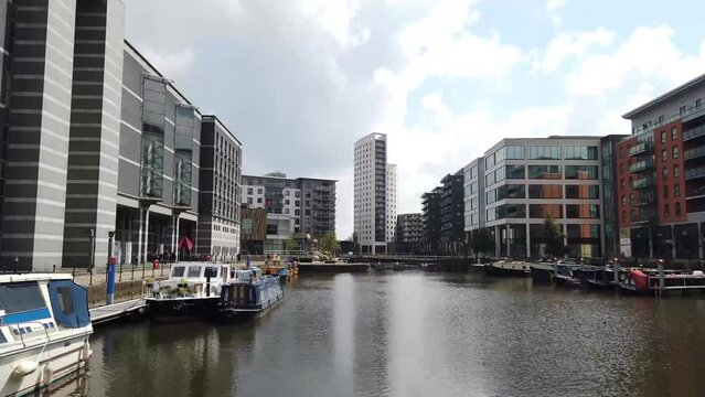 Time lapse footage of the area in the Leeds town centre know as The Leeds Dock, on a bright sunny summers day showing the River Aire with barges and The Water Taxi
