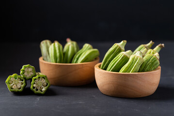 Green okra or ladies' fingers (Edible green seed pods), Organic vegetables from local farmer market - obrazy, fototapety, plakaty
