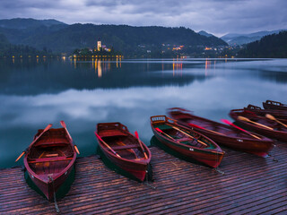 Pletna rowing boats and Lake Bled Island at twilight, Bled, Gorenjska, Slovenia, Europe