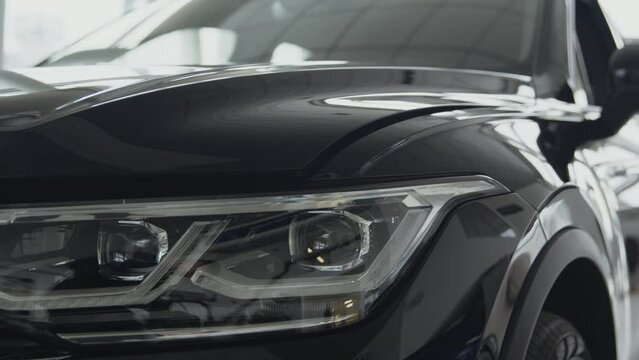 New modern automobile. Tracking shot presentation of brand new suv car at dealership auto salon