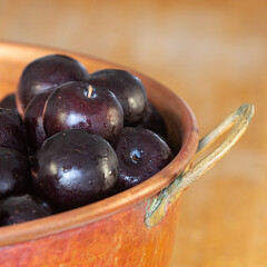 plums in copper pan