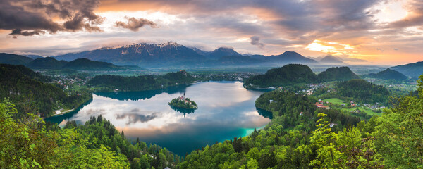 Beautiful Lake Bled and mountain landscape under dramatic sunset sky and clouds, seen from Osojnica...