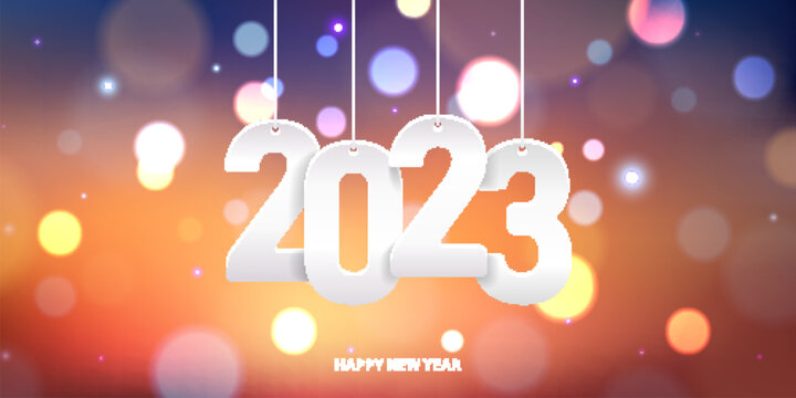 Happy new year 2023. Hanging white paper number on a colorful blurry background.