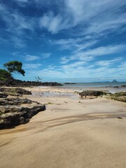 beach with blue sky and rocks