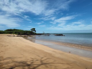 beach with blue sky and rocks