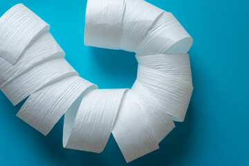white paper ribbon coil on a blue background