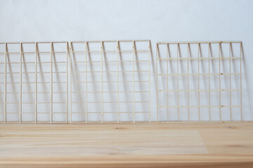wooden grids on a wooden plank against a grungy canvas background