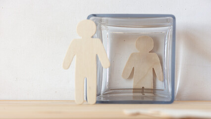 angel and devil or wooden figures and glass jar