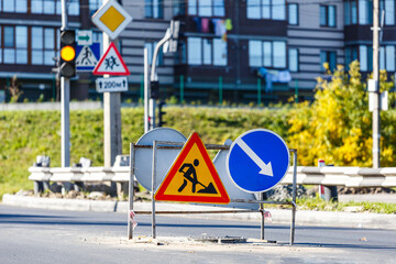 Road signs!Road works with trucks and traffic signs.road works road blocked signs and traffic cones...