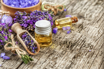 lavender's spa products with dried lavender flowers on a wooden table. Flat lay bath salt and...