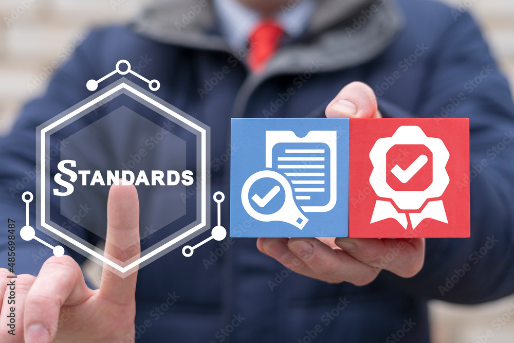 Poster standards law compliance regulations business concept. businessman holding colorful polystyrene bloc