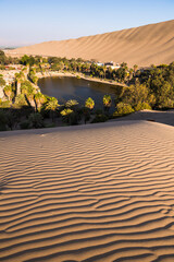 Sunset at Huacachina, a sand dunes surrounded oasis village in the desert, Ica Region, Peru, South...