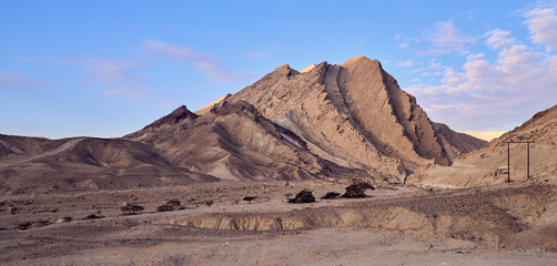 Desert landscape with almost vertical walls of the Small Crater in Negev desert, Israel. Steep walls of the Hamakhtesh Hakatan, a geological erosional landform of Negev desert.