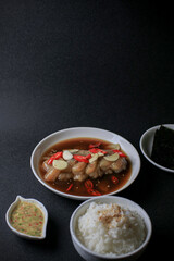 Pickled shrimps (Saewoo-Jang), marinate raw shrimps with chili, garlic and soy sauce on dark background. Korean food.