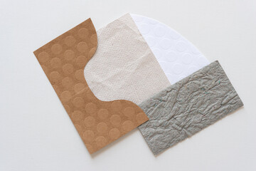 paper shapes in brown, beige, stone white, and gray