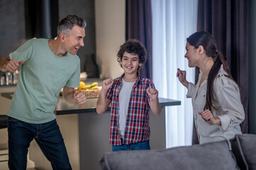 Man woman and boy dancing at home