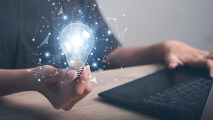 Learning online, E-learning,  Business studying concept. Laptop and glowing light bulb digital line...