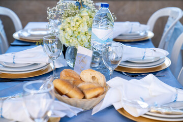 Table Setting at a Baptismal Religious Event with Bread and Water in the foreground