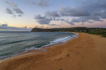 Breezy aerial sunrise seascape with clouds
