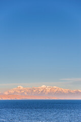 Cordillera Real Mountain Range sunset (part of Andes Mountain Range) and Lake Titicaca, seen from Isla del Sol, Bolivia, South America
