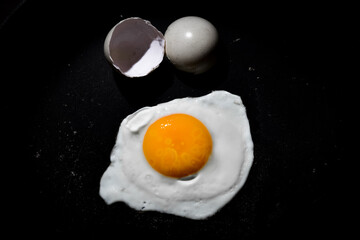 Delicious and healthy half boiled egg on black background. South Indian special dish.