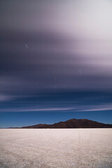 Fototapeta premium Star trails above Uyuni Salt Flats at night (Salar de Uyuni), Uyuni, Bolivia, South America