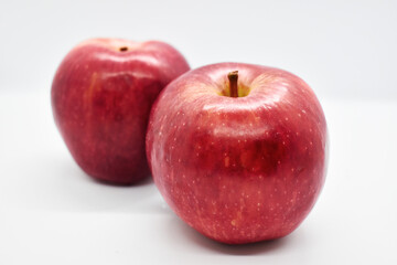 Studio shot of red apples with leal isolated on white background