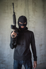 Portrait robbery man standing is holding M16 gun on hand, kidnapping Thief robber