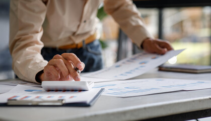 Business man hands hold documents with financial statistic stock photo,discussion and analysis data the charts and graphs. Report Finance concept
