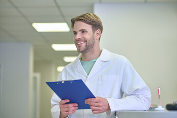 Young male doctor smiling and looking positive