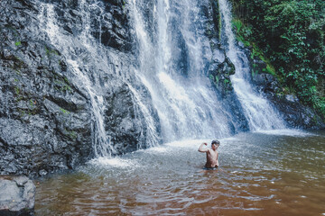Boy in the waterfall