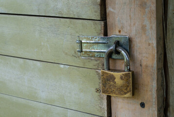 Closed old door. old padlock.