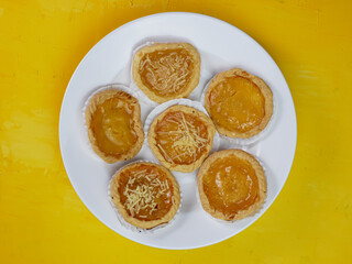 Pineapple and cheese flavored pie on orange background