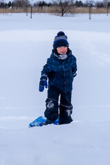 Fototapeta na wymiar Young boy enjoying the winter while carrying a winter sled. High quality photo