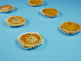 Pineapple and cheese flavored pie on blue background