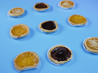 Pie flavored with chocolate, pineapple, and cheese on blue background