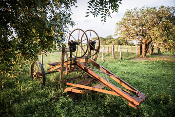 Rusty old farm machinery at Estancia San Juan de Poriahu, a traditional Argentinian cattle farm in...