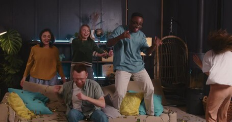 Cheerful happy multiethnic student friends celebrate success dancing together at vacation holiday party, music is ending