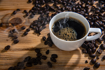 roast coffee beans and hot black cup of coffee