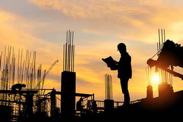 Silhouette of Engineer and workers checking project at building site, worker team at construction...