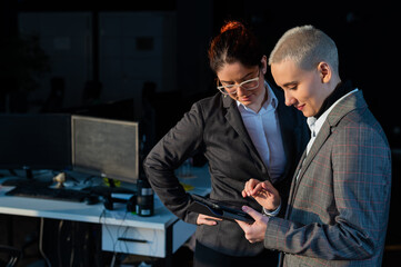 Friendly colleagues looking at a digital tablet. 